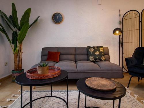 a living room with a couch and two tables at Apartment Nueva Playa-1 by Interhome in Les Deveses	