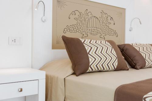 a bedroom with a bed and a wall with a picture of grapes at La Vinia Bed&Wine Experience - Adults Only in Sassari