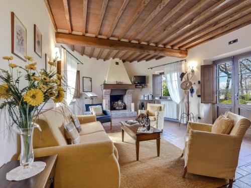 a living room with a couch and chairs and a fireplace at Holiday Home Villa del Poggio by Interhome in Radda in Chianti