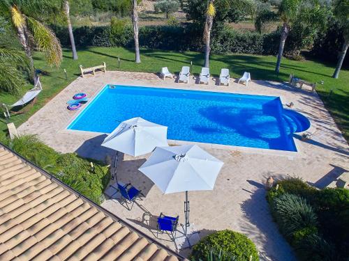 an overhead view of a swimming pool with umbrellas at Villa Bel Villa by Interhome in Marinella di Selinunte