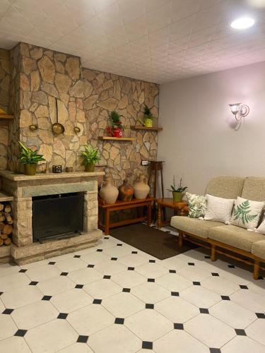 a living room with a stone wall and a fireplace at Charming 8-Bed Villa in Girona in Girona