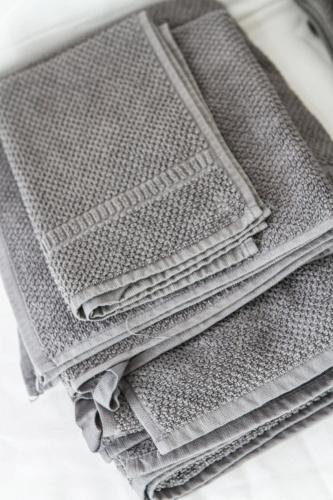 a pile of grey woven towels sitting on a table at Dolce Dormire Suite in Arcola