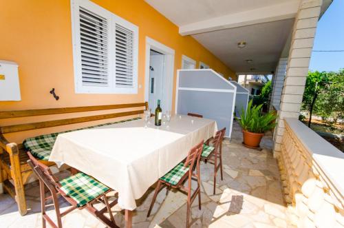 a table and chairs on the patio of a house at Apartments Ivana in Trogir