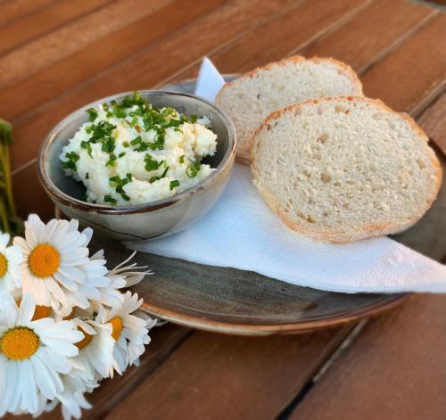 a plate with a bowl of cottage cheese and a bowl of bread at Penzión Solisko*** Oščadnica in Oščadnica
