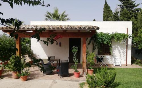 a house with a patio with a table and chairs at La casa del melograno in Marsala