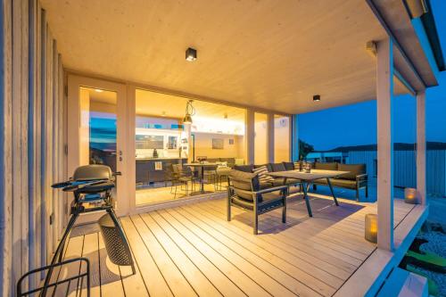 a patio with a table and chairs on a deck at Buqez Resort Villa 46 in Drage
