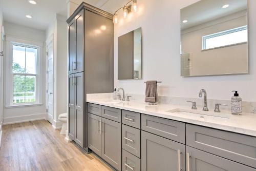 a bathroom with two sinks and a mirror at Coastal Waveland House half Block to Pub Beach in Waveland
