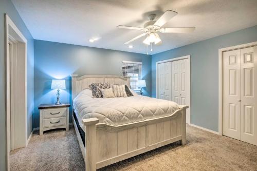 a bedroom with a bed and a ceiling fan at Holiday Island Home Fire Pit and Boat Parking! in Golden