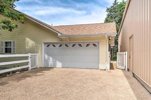 a house with a garage and a driveway at Holiday Island Home Fire Pit and Boat Parking! in Golden