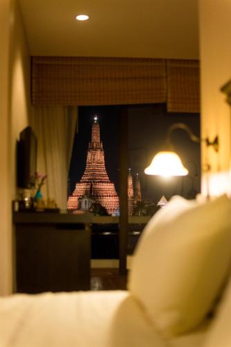a hotel room with a view of the eiffel tower at Arun Residence in Bangkok