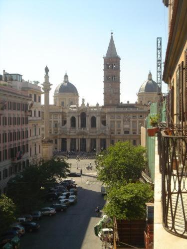 a large building with a clock tower and a street with cars at Hotel d'Este in Rome