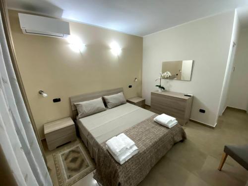 a bedroom with a bed with two towels on it at B&B Mediterraneo in Torre Melissa