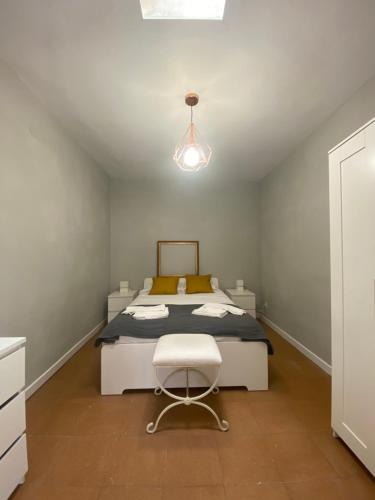 a bedroom with a bed and a chair in it at Palacete Plaza Mayor in El Burgo de Osma