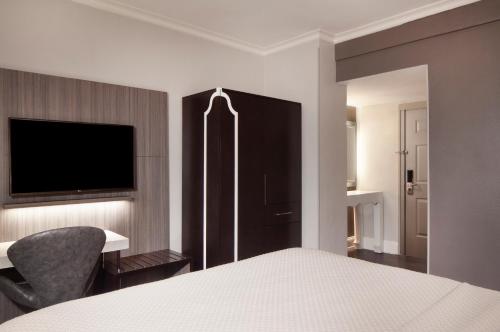 a hotel room with a bed and a television at Hotel Indigo Atlanta Midtown, an IHG Hotel in Atlanta