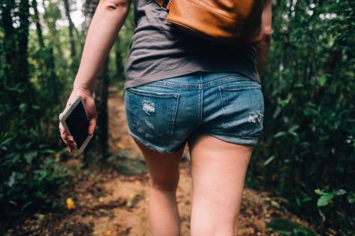 a woman walking down a trail in the woods at Cerrito Tropical Eco Lodge in Taboga