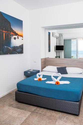 a bedroom with a bed with two towels on it at A Tonnara in Cefalù