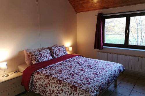 a bedroom with a bed and a window at Lo'rée des prés in Grandriaux