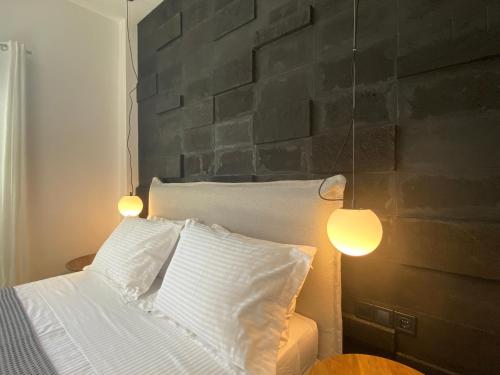 a bedroom with a bed with two lamps on it at Marton Perissa in Perissa