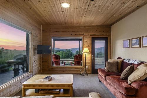 a living room with a couch and a large window at This is the ultimate in private escape in Ponca