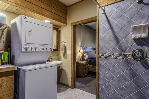 a bathroom with a washer and dryer next to a shower at This is the ultimate in private escape in Ponca