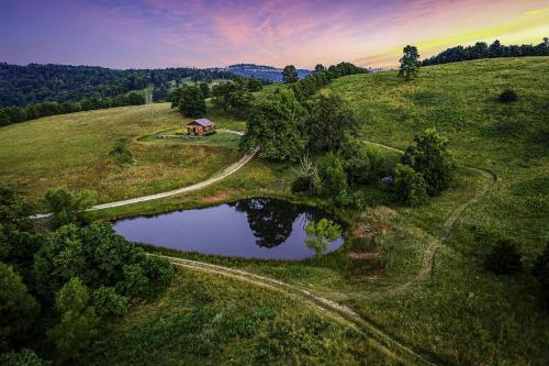 an aerial view of a house on a hill with a pond at This is the ultimate in private escape in Ponca
