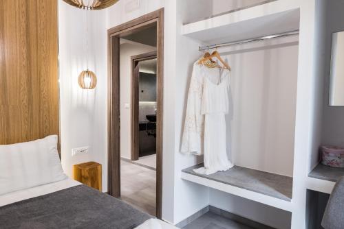 a bedroom with a bed and a mirror at Poseidon close to the beach in Agios Nikolaos