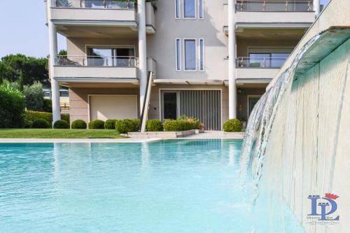 a swimming pool in front of a building at Oscar Luxury Suite DesenzanoLoft Official Partner Homes & Villas by Marriott Bonvoy in Desenzano del Garda