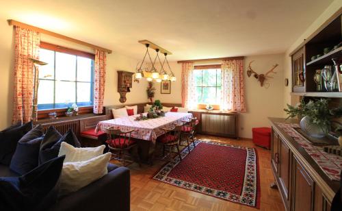 a living room with a dining room table and chairs at CHALET WIESERNOCK in Bad Kleinkirchheim