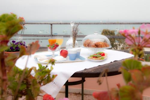 a table with food and drinks on a balcony at La Dolce Vista - B&B di Charme in Manfredonia