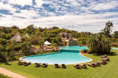 an image of a pool at a resort with lawn chairs at Arabella Hotel, Golf and Spa in Kleinmond