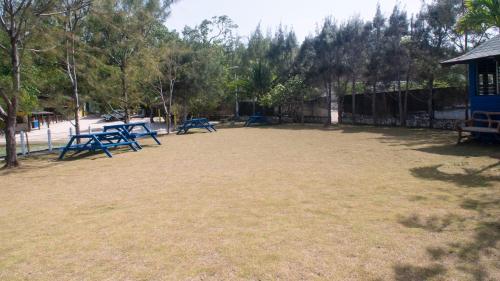 a playground with blue picnic tables in a park at Sunset Nabro in St Mary