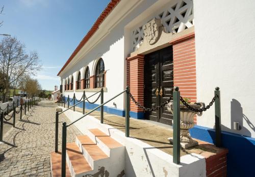 a building with stairs in front of a store at Escola do Fado in Vila Fernando