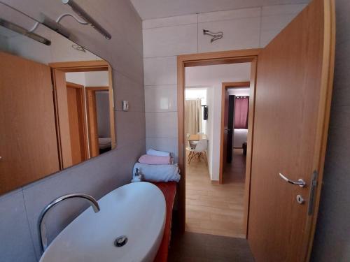 a bathroom with a white sink and a mirror at Frane Apartment in Zavalatica
