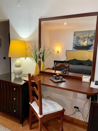 a room with a desk with a mirror and a piano at Hotel Rural A Coutada - Peniche in Atouguia da Baleia