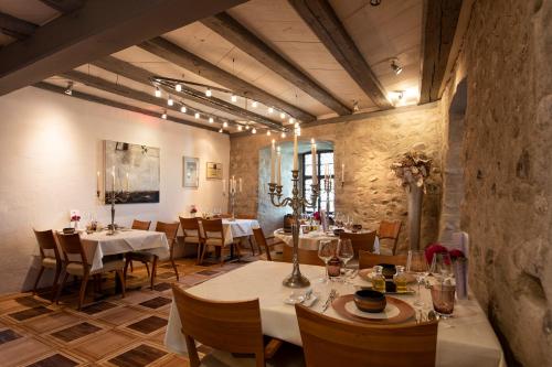 a restaurant with tables and chairs in a room at Hotel de Charme Römerhof in Arbon