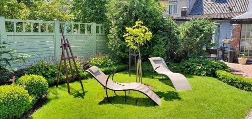 a garden with two slides on the grass at Vila Florena in Palanga