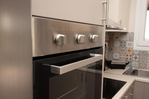 a stainless steel oven in a small kitchen at Nausika Cottage Corfu in Paleokastritsa