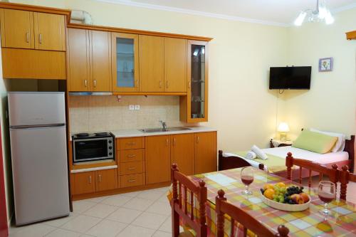 a kitchen with a table with a bowl of fruit on it at Miracle Apartments Saranda in Sarandë