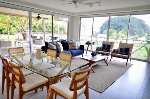 a living room with a glass table and chairs at Azuero Lodge: Luxury Beachfront condo- Playa Venao in Playa Venao