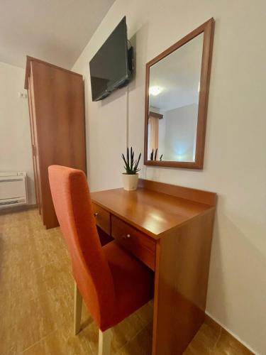 a desk with a mirror and a chair in a room at Apartments Boreta Becici in Budva