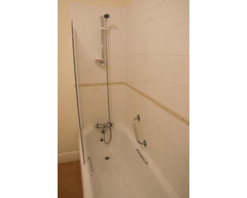 a bathroom with a shower and a bath tub at Diamond Hotel in Torquay