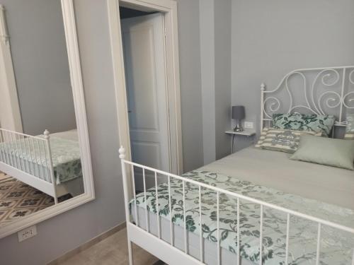 a bedroom with a bed and a mirror at B&B Puglia d'aMare in Lizzano