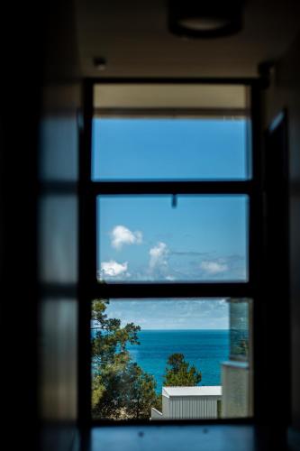 a view of the ocean from a window at Chveni Ezo Boutique Hotel in K'obulet'i