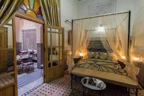 a bedroom with a canopy bed in a room at Riad Taryana in Fez