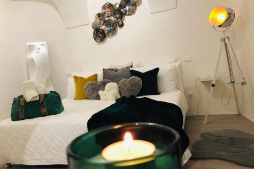 a room with a bed with a candle on it at Le Bijou di Dolceacqua, per un momento memorabile. in Dolceacqua