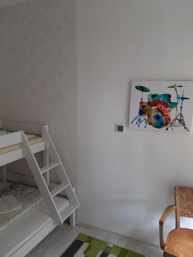 a room with a bunk bed and a painting on the wall at Penzion U Žabáka in Mikulov