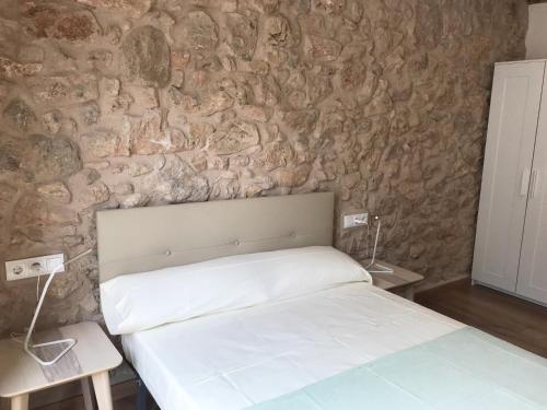 Ένα ή περισσότερα κρεβάτια σε δωμάτιο στο Apartaments Casa el Metge
