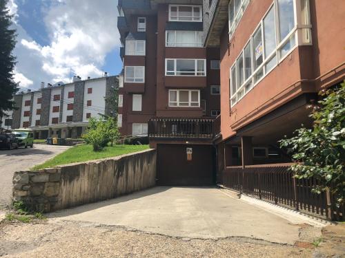 a brick building with a garage in front of it at CHECK-IN CASAS Cerler 3F in Cerler