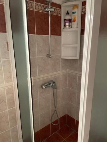 a shower with a hose in a bathroom at Sweet dreams at the seaside in Skála Foúrkas