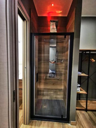 a room with a glass door leading into a room at B&B Be happy in Taranto